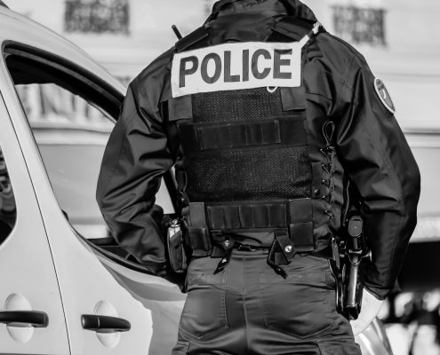 police officer or law enforcement in tactical gear showing a police patch